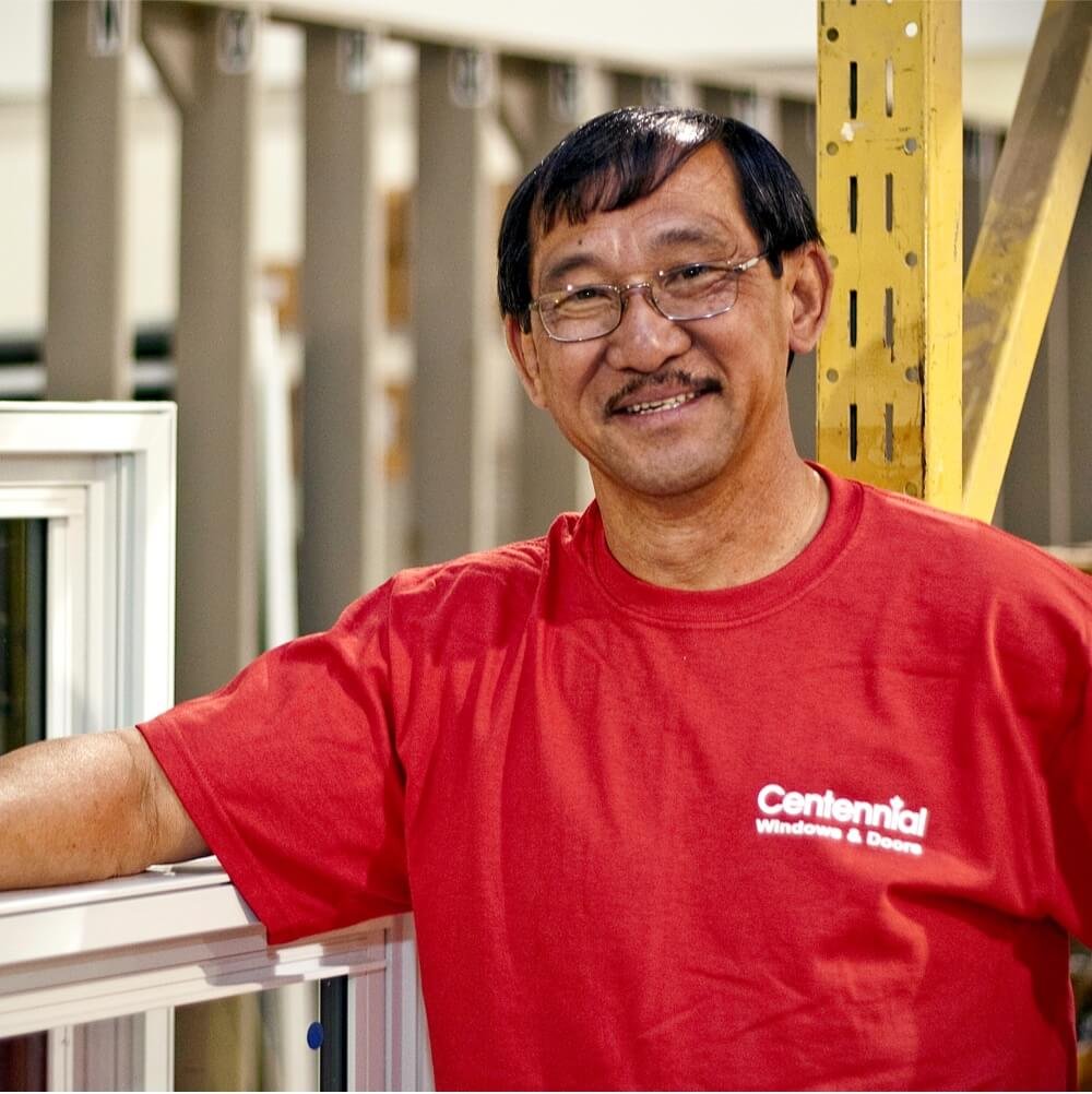 Centennial Windows and Doors Employee Smiling Inside Manufacturing Facility