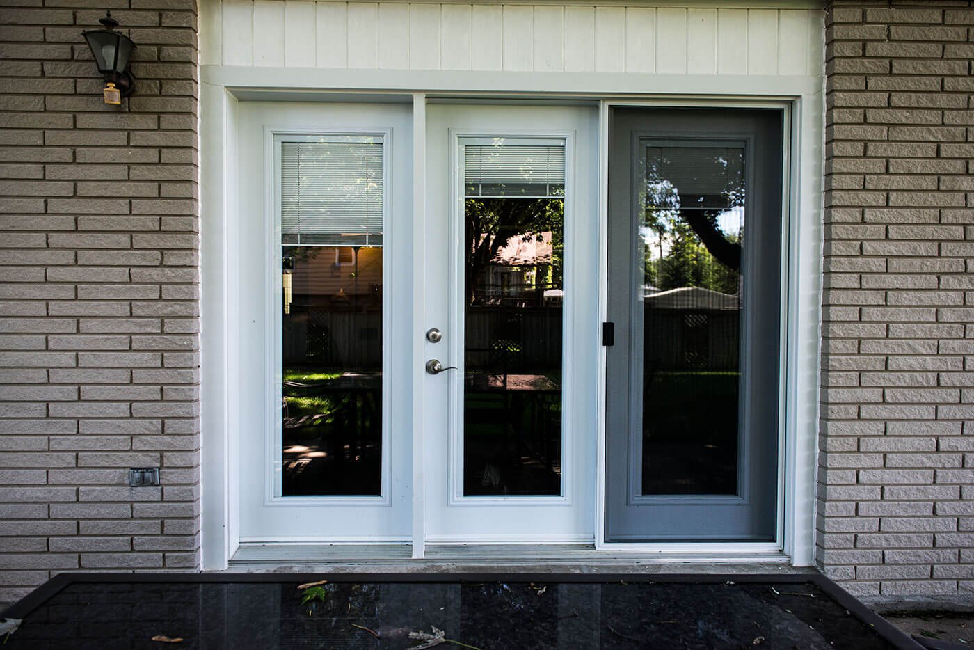 Black Marble Backyard Patio with Custom Manufactured White Garden Doors